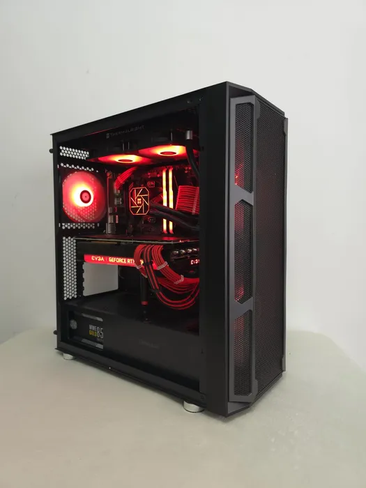 Black PC with red lighting, red cables and a visible graphics card
